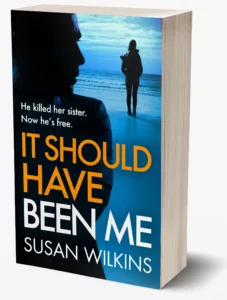 Crime thriller fiction from Susan Wilkins Book Cover image for It Should Have Been Me.Female figure looking out to sea being watched by sinister male figure